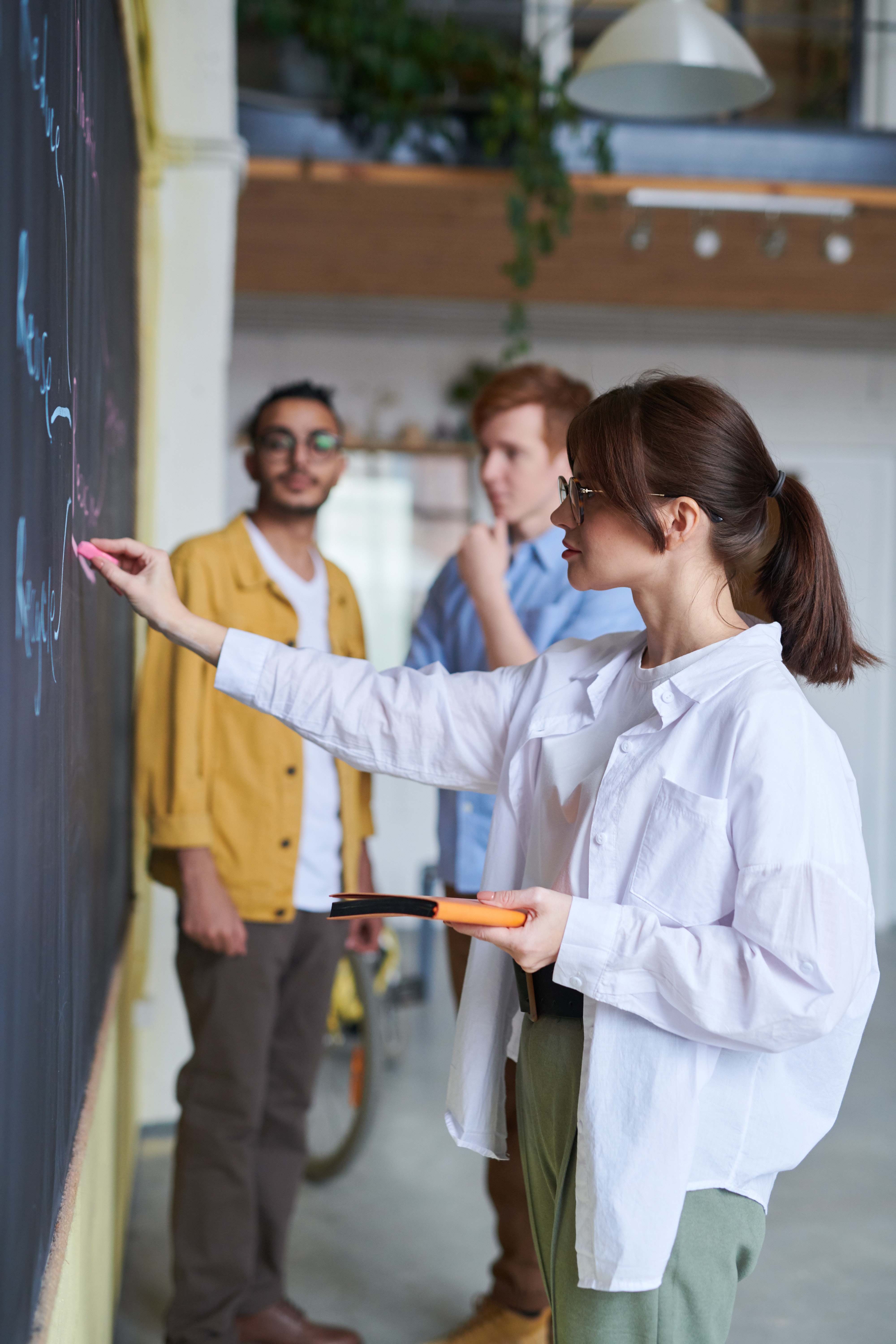 Woman drawing on blackboard